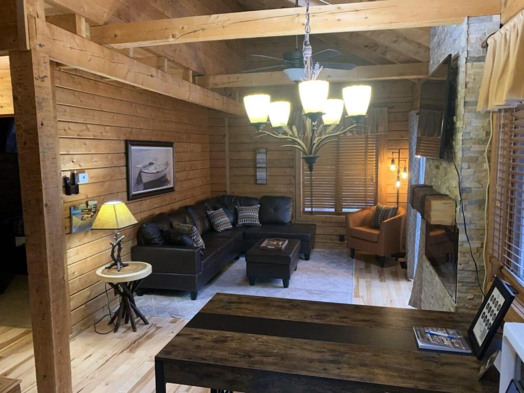 a living room with a couch and a table at Crystal Mountain Cabin Get Away in Thompsonville
