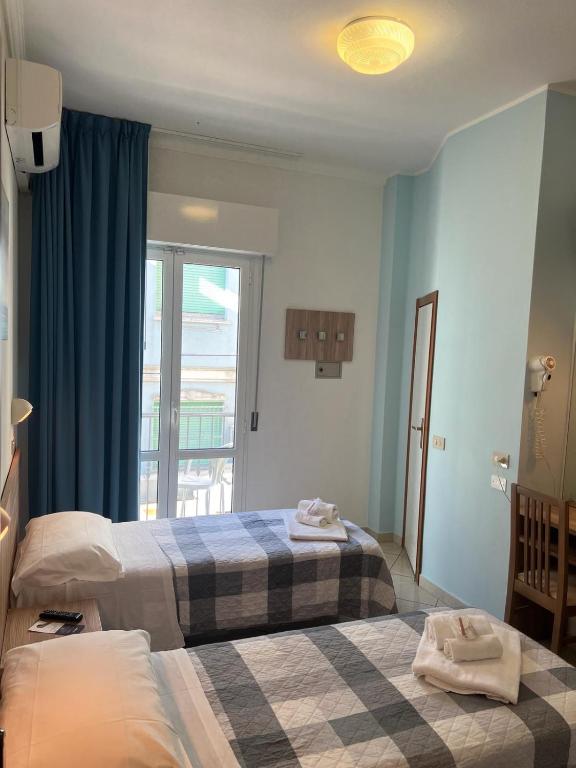 Postel nebo postele na pokoji v ubytování Hotel Blue Ribbon