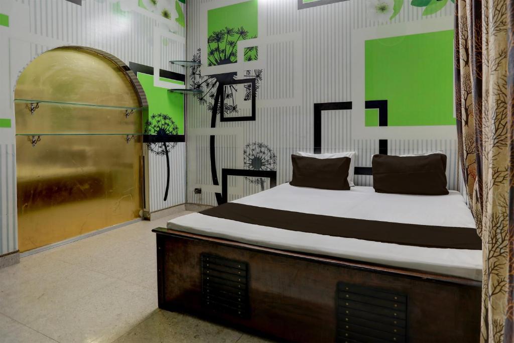 Un pat sau paturi într-o cameră la OYO Home 82227 Malik Hotel