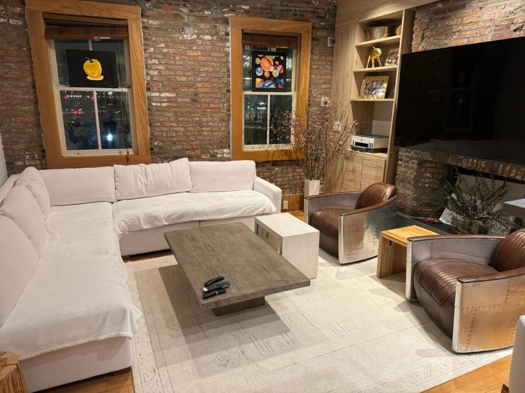 a living room with a couch and a coffee table at Tribecca Modern Brick Wall 3BR 2BA in New York