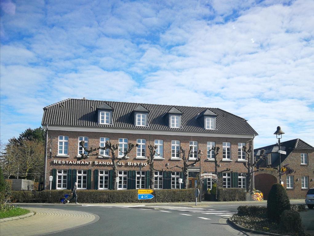 a large brick building with a black roof at Wachtendonker Hof in Wachtendonk
