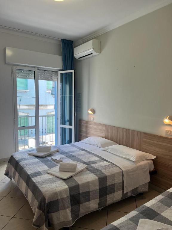 Postel nebo postele na pokoji v ubytování Hotel Blue Ribbon