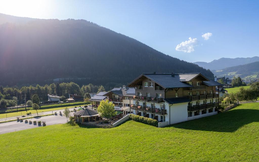 an aerial view of a building with a mountain in the background at Landhotel Berger in Eben im Pongau