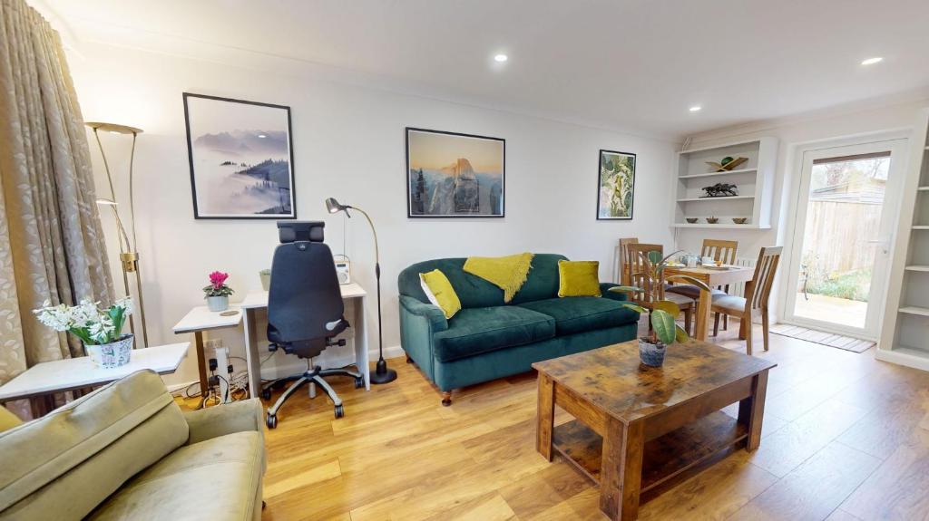 a living room with a couch and a table at Cherry Tree Cottage in Bicester