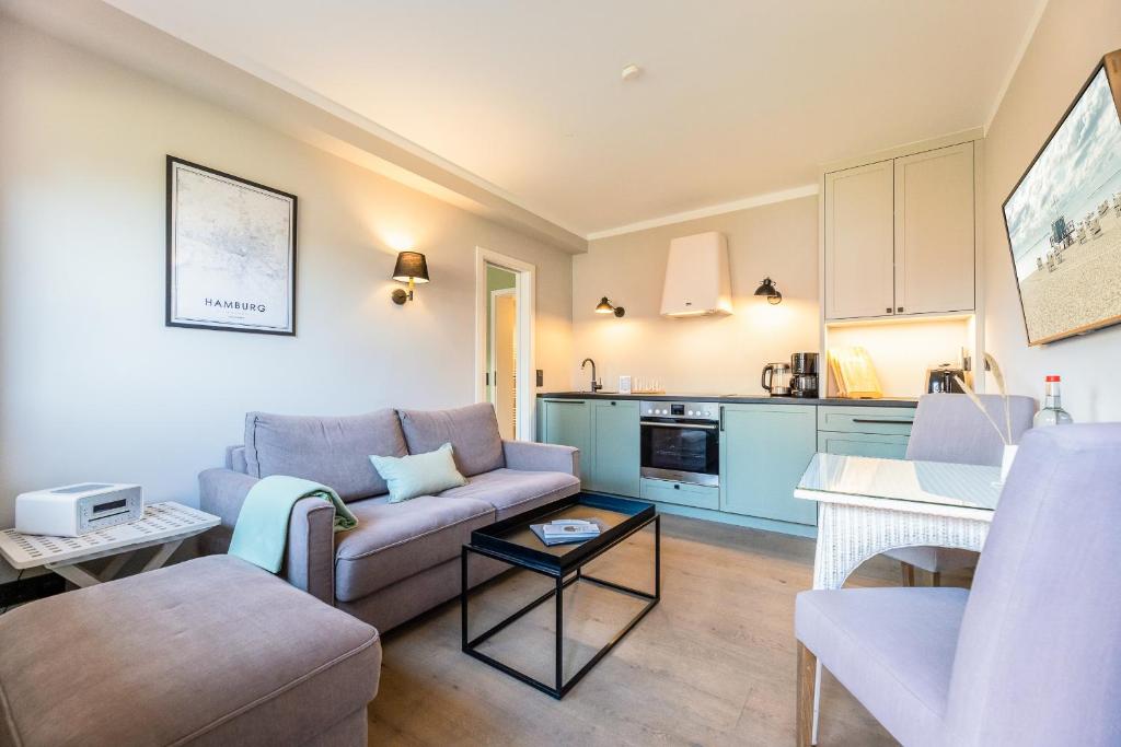 a living room with a couch and a table at Appartement Hamburg in Westerland