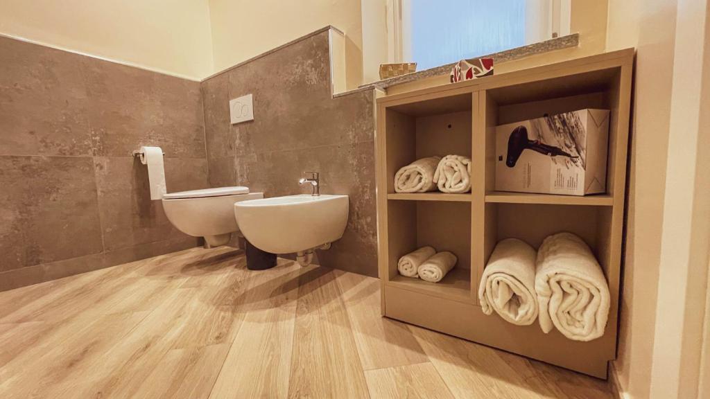 bagno con lavandino, servizi igienici e asciugamani di GIO' HOUSE a Fossano