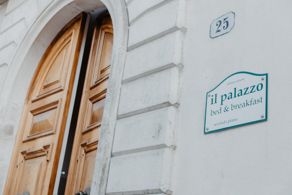 a sign on the side of a building with a door at Il Palazzo in Scanno