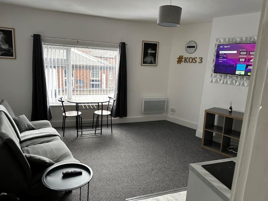 a living room with a couch and a table at Kos apartment 3 in Walton on the Hill