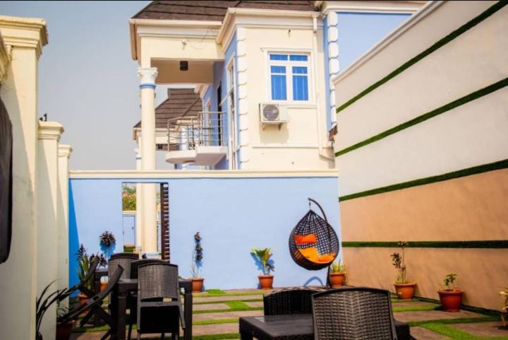 a view of a house with a patio with chairs at HOTEL D RITZ in Aba Adi