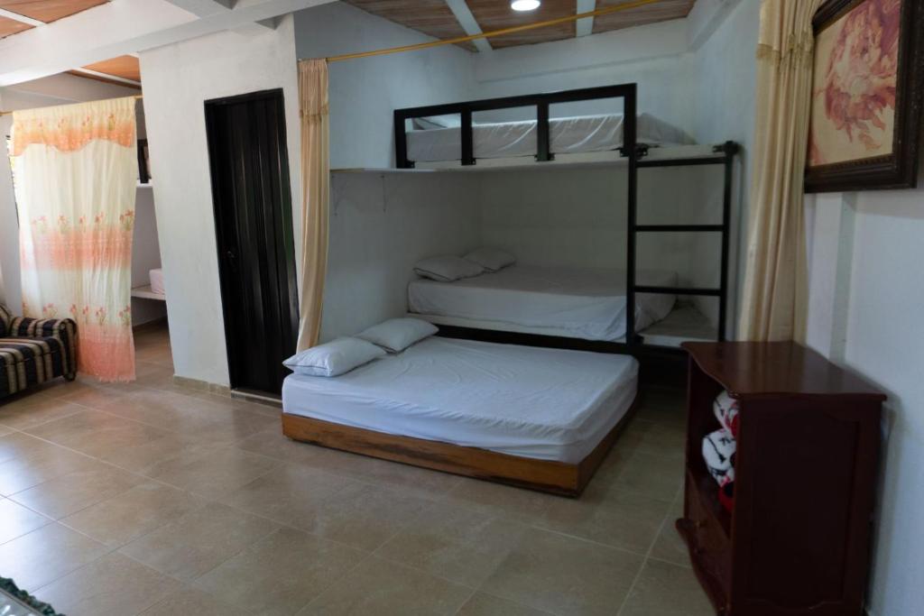 a bedroom with two bunk beds and a couch at el paraiso de juanjo in San Carlos