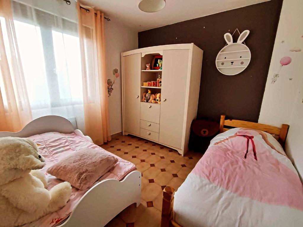 a small bedroom with a teddy bear on a bed at Appartement chez Eline in Les Angles Gard