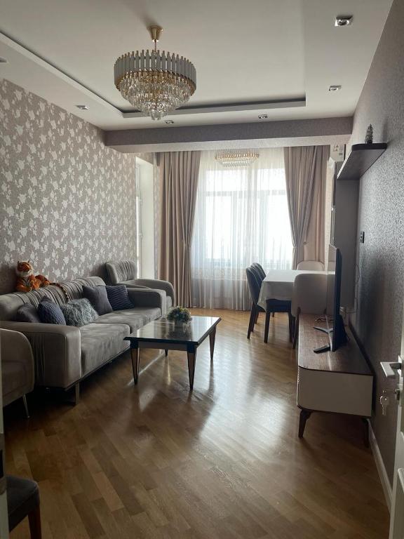 a living room with a couch and a table at Blue Residence Baku in Baku