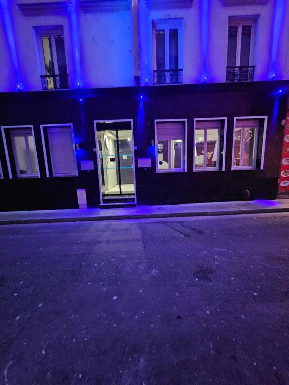 an empty street in front of a building at night at Modern's Hotel in Paris