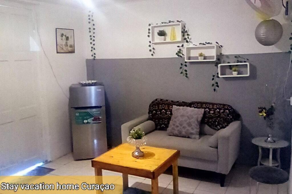 a living room with a couch and a coffee table at stay vacation home curaçao in Willemstad