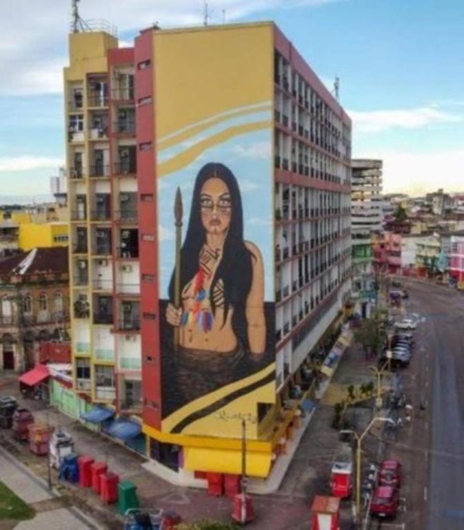 a building with a large painting on the side of it at Apartamento Centro Manaus 721 in Manaus