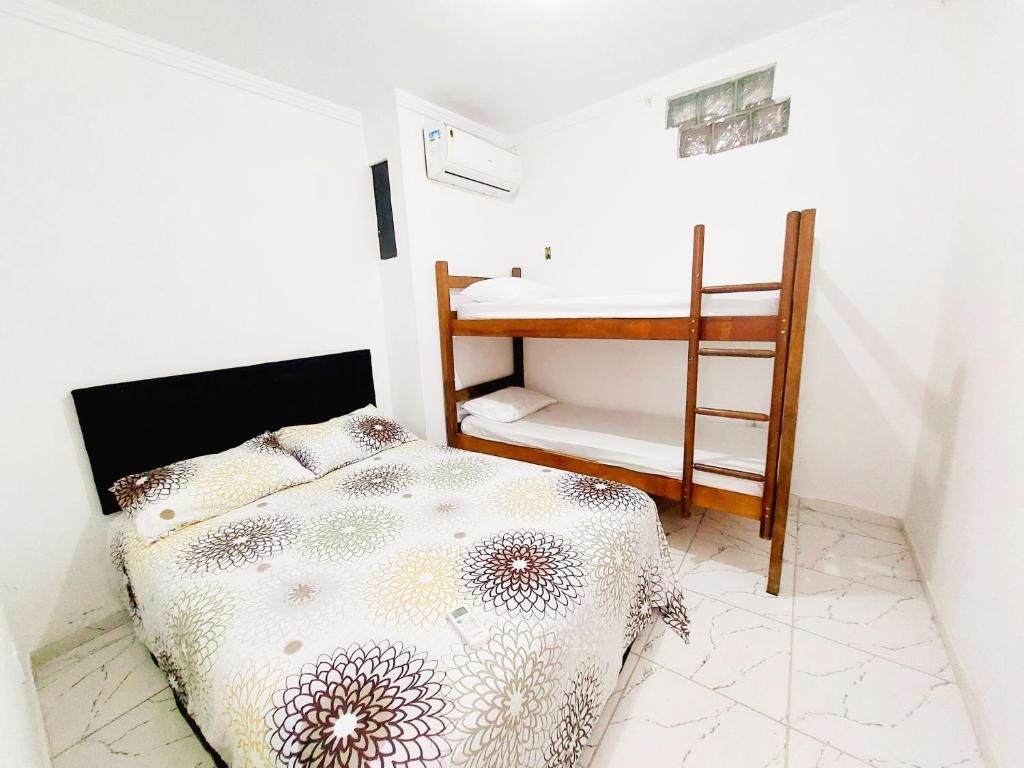- une petite chambre avec un lit et un bureau dans l'établissement Kitnet Quarto Sala Cozinha com Ar Condicionado 102, à Cabo Frio