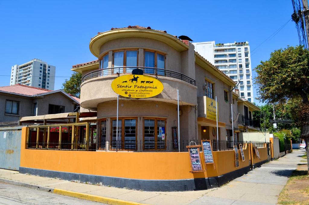 a building with a sign on it on a street at Sentir Patagonia in Viña del Mar