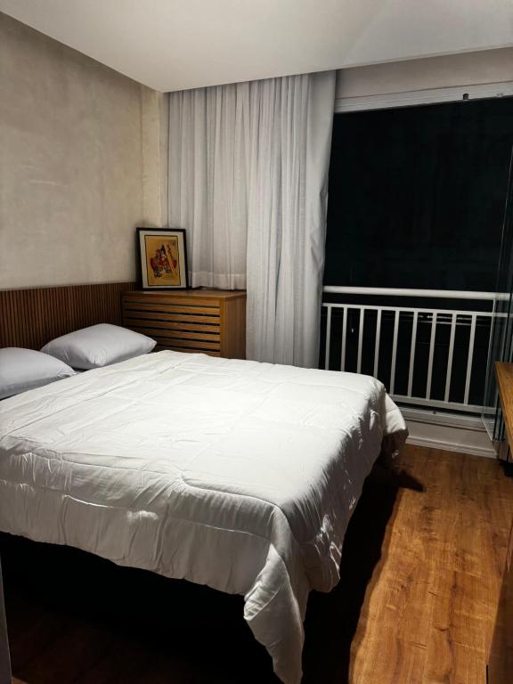 מיטה או מיטות בחדר ב-Studio Itaquera Neoquimica Arena