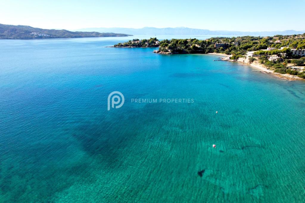 an aerial view of a beach with turquoise water at Villa Tranquility - Walk to the Beach with Infinity Pool in Porto Heli