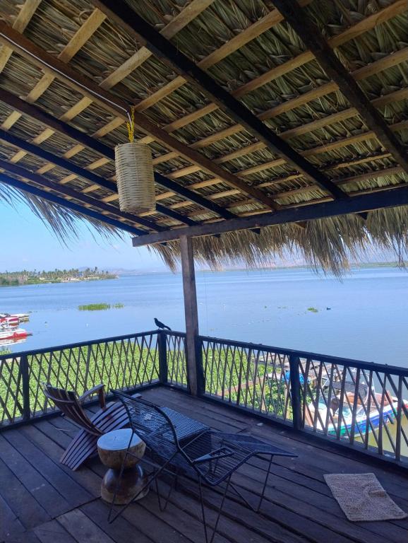 a porch with a view of the ocean and a beach at Club Cadena in Acapulco