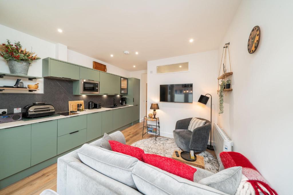 a living room with a couch and a kitchen at Grange8 Luxury Snug & Courtyard in Blairgowrie in Blairgowrie