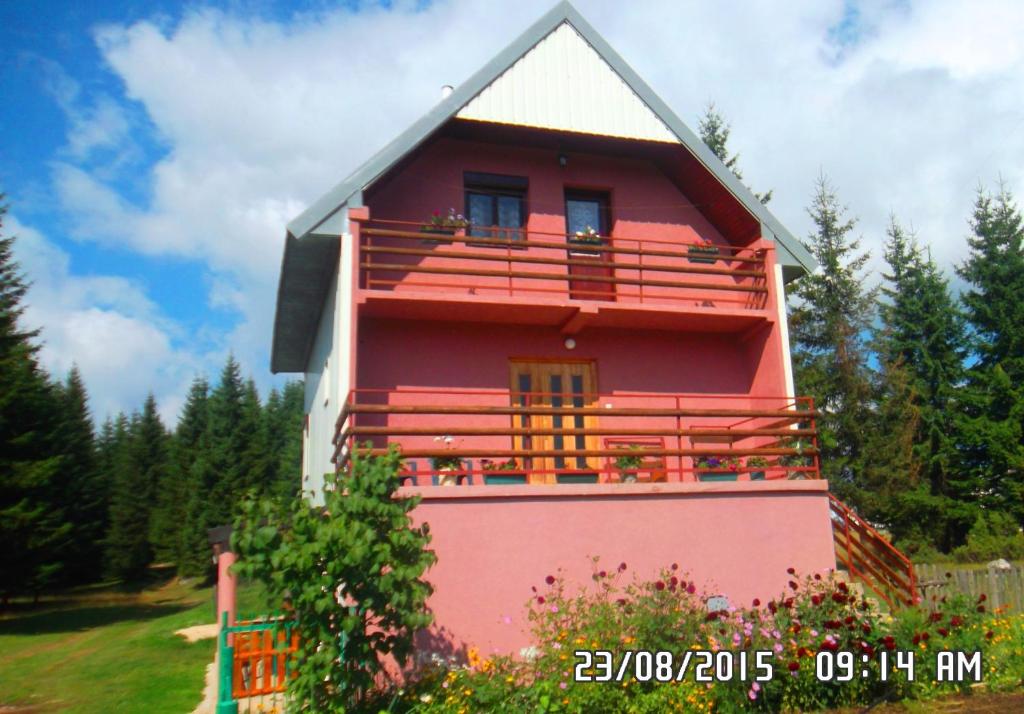 a red and white house with a balcony at Apartment Luka in Žabljak