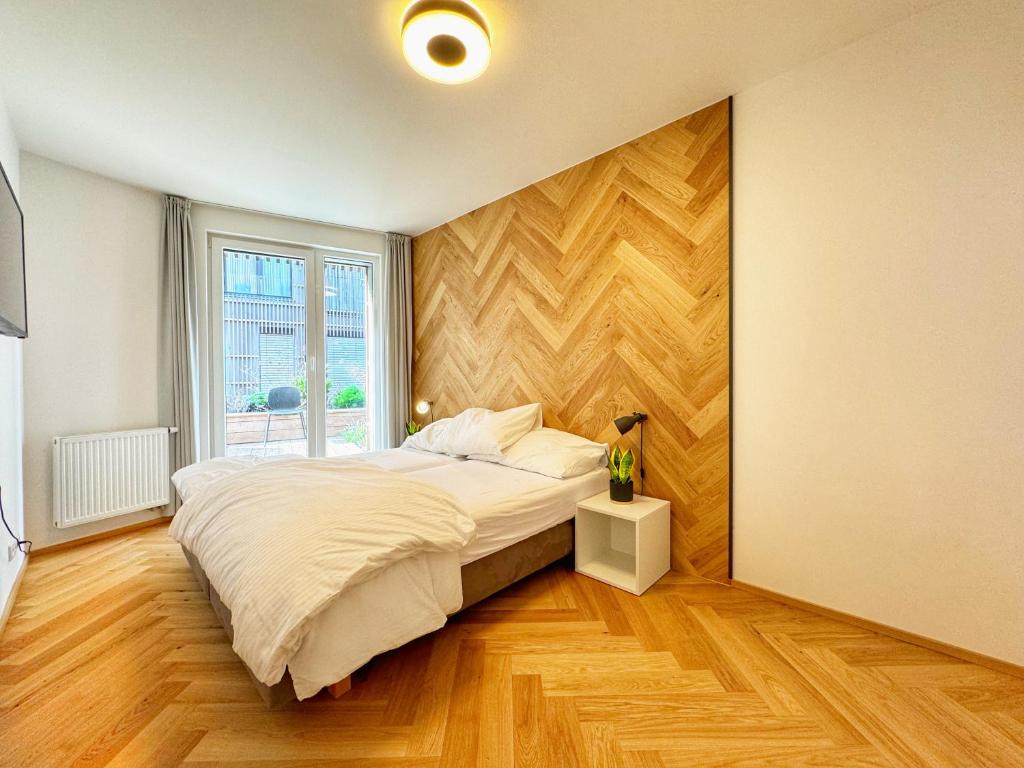 a bedroom with a large bed and a window at LuxuryLake apartmán in Doksy