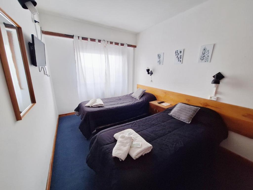 מיטה או מיטות בחדר ב-Hosteria Puyehue