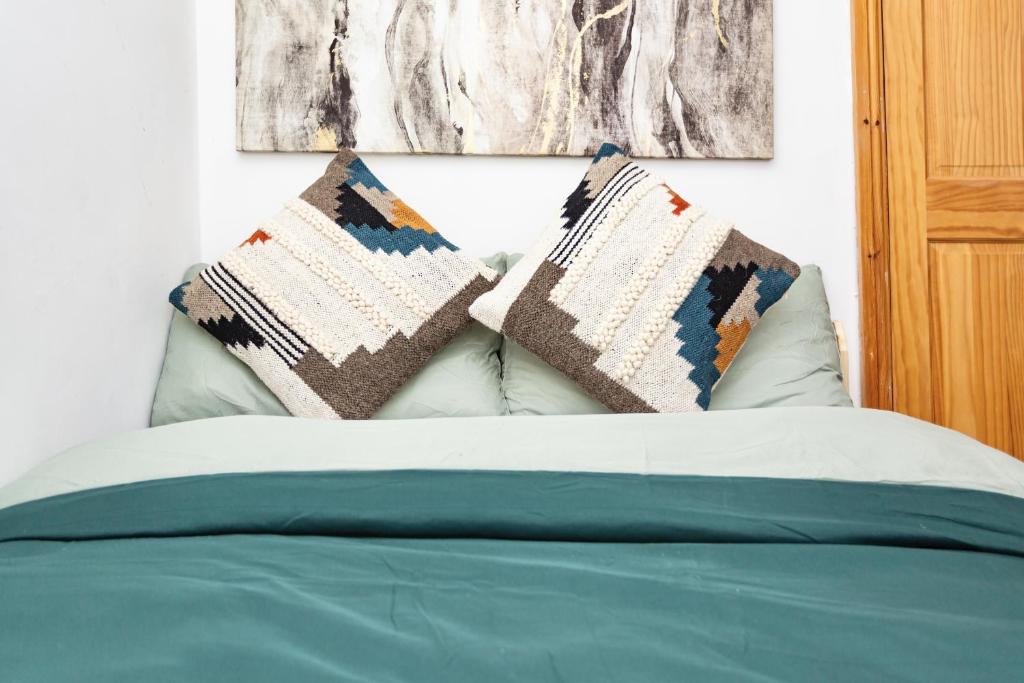 a bed with two pillows on top of it at Everest Home in Nottingham