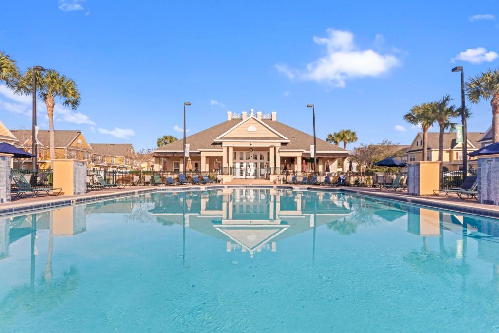 a large swimming pool in front of a house at The Villas at Seven Dwarfs - 4564 Luxury Villa - Near Disney - Water Park in Kissimmee