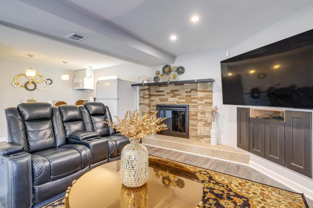 a living room with a couch and a fireplace at Pet-Friendly Woodbridge Retreat Near Potomac Mills in Woodbridge