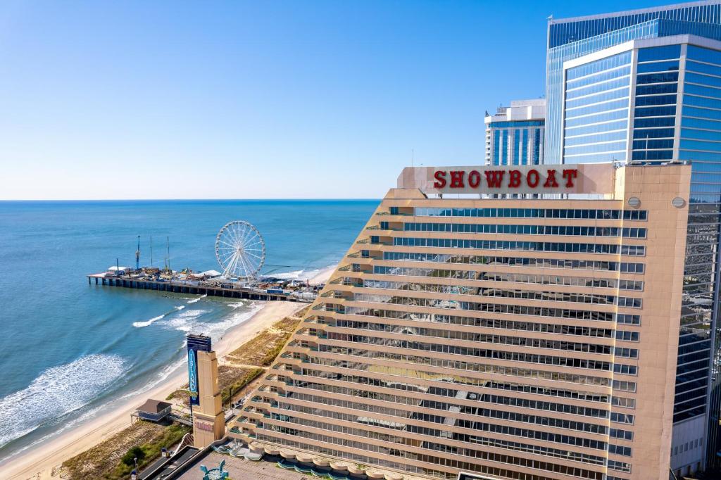 a building with a sign on it next to the ocean at Showboat Hotel Atlantic City in Atlantic City