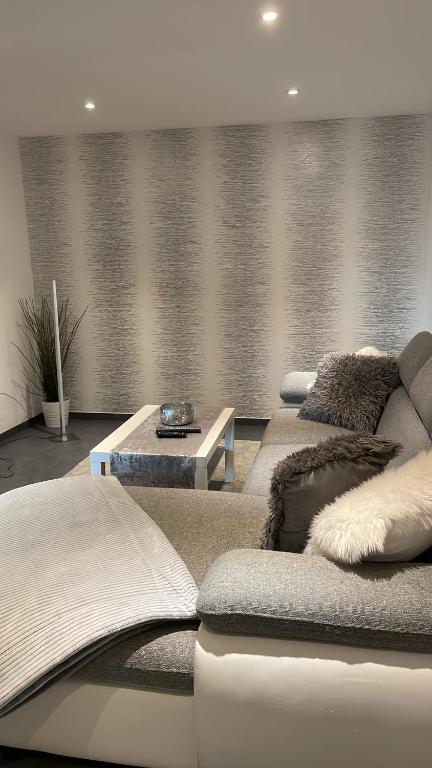 a living room with two couches and a table at DeuxPonts Ferienwohnung in Zweibrücken