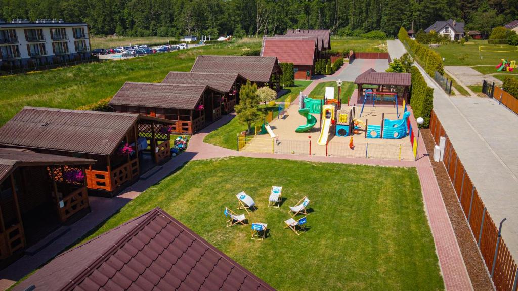 an aerial view of a playground with a park at Domki Wypoczynkowe Letnia Przygoda in Mielno