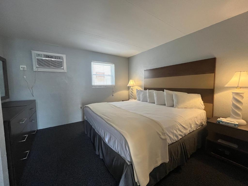 a hotel room with a large bed and a window at Granada Ocean Resort in Wildwood Crest