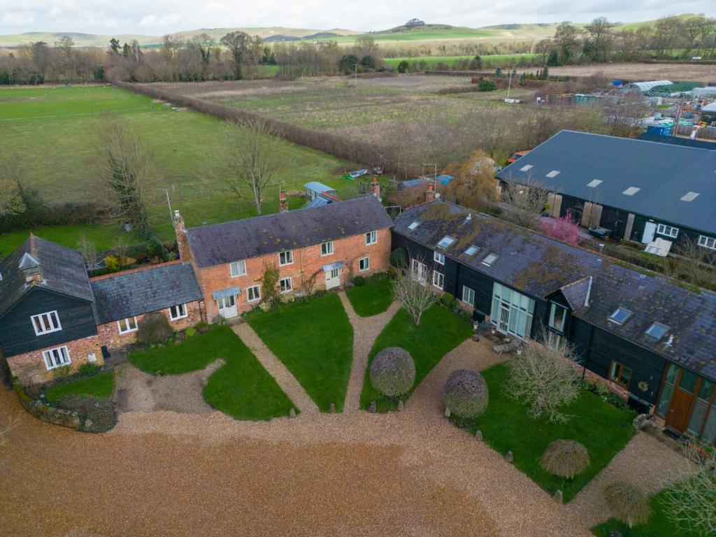 an aerial view of a large house with a yard at Charming Barn Retreat Near Pewsey & Woodborough in Woodborough