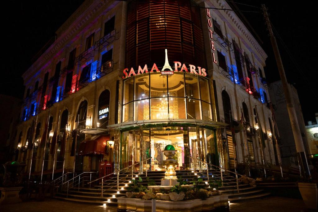 安曼的住宿－Sama Paris Plaza Hotel，前面有标志的大建筑