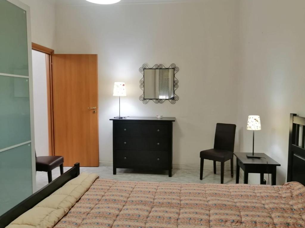 a bedroom with a bed and two chairs and a desk at Casa Mirandola in Rome