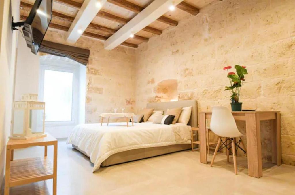 a bedroom with a bed and a stone wall at Urban Flat Garibaldi - TimeSRL Apartments in Bari