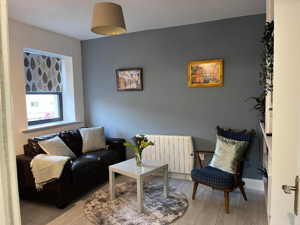 a living room with a couch and a table at Woodquay Mews in Galway