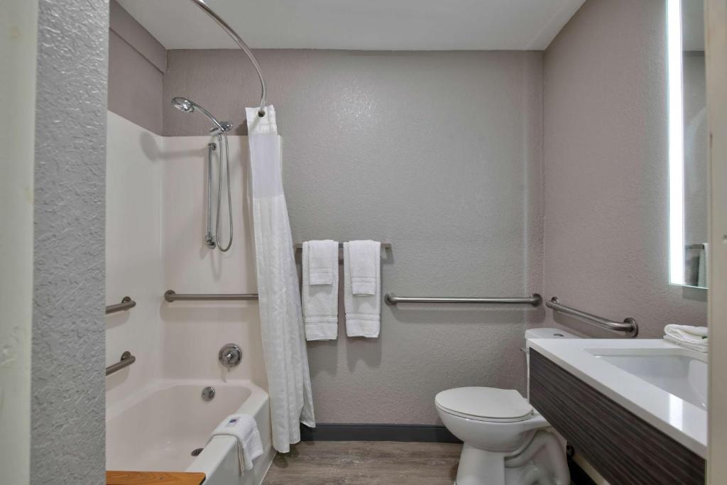 a bathroom with a toilet and a tub and a sink at Motel 6-Atlanta, GA - Downtown in Atlanta