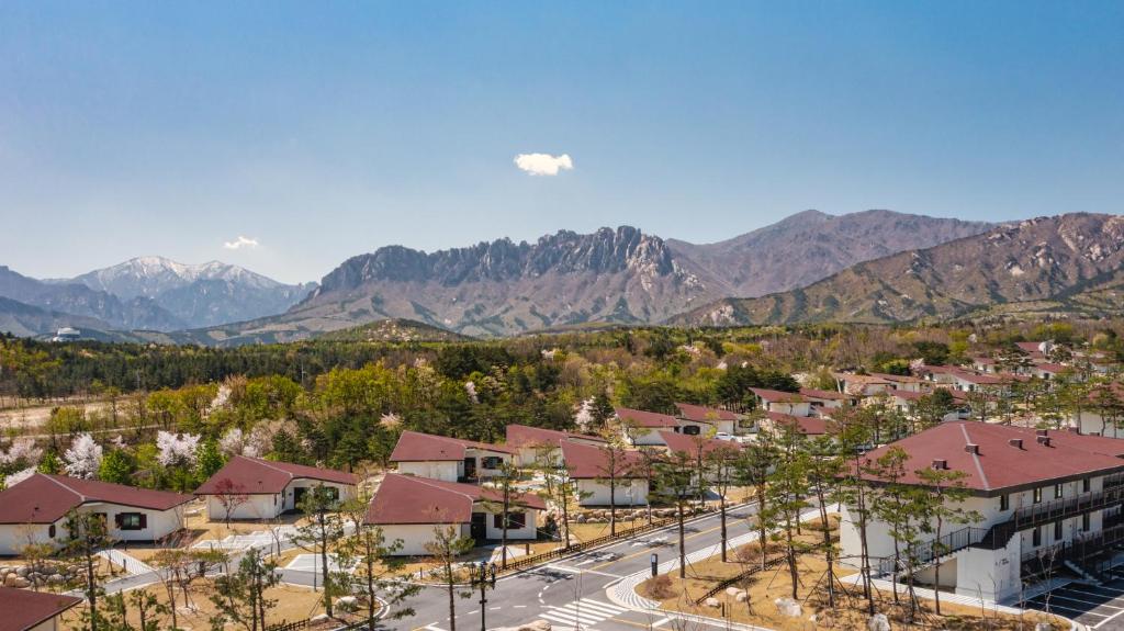 an aerial view of a town with mountains in the background at Kensington Resort Seorak Valley in Sokcho