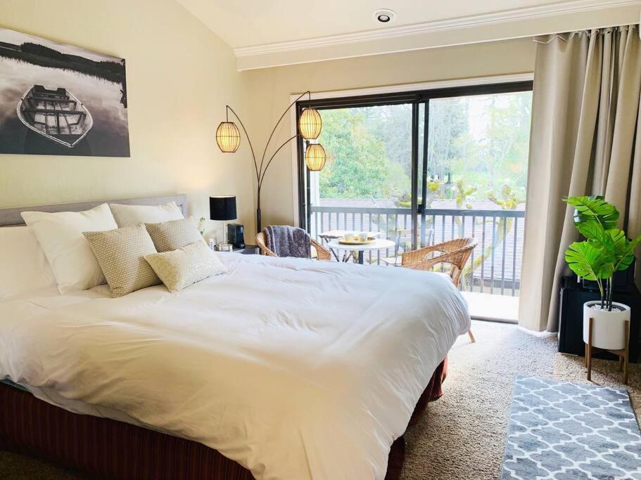 a bedroom with a large bed and a balcony at Couple's Retreat in Napa Valley Near Wineries in Napa