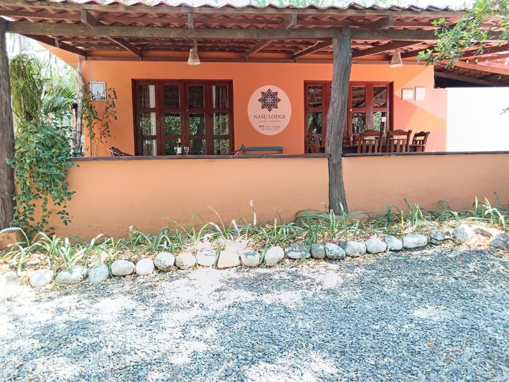 a building with a table and chairs in front of it at Casa Amapola in La Cruz