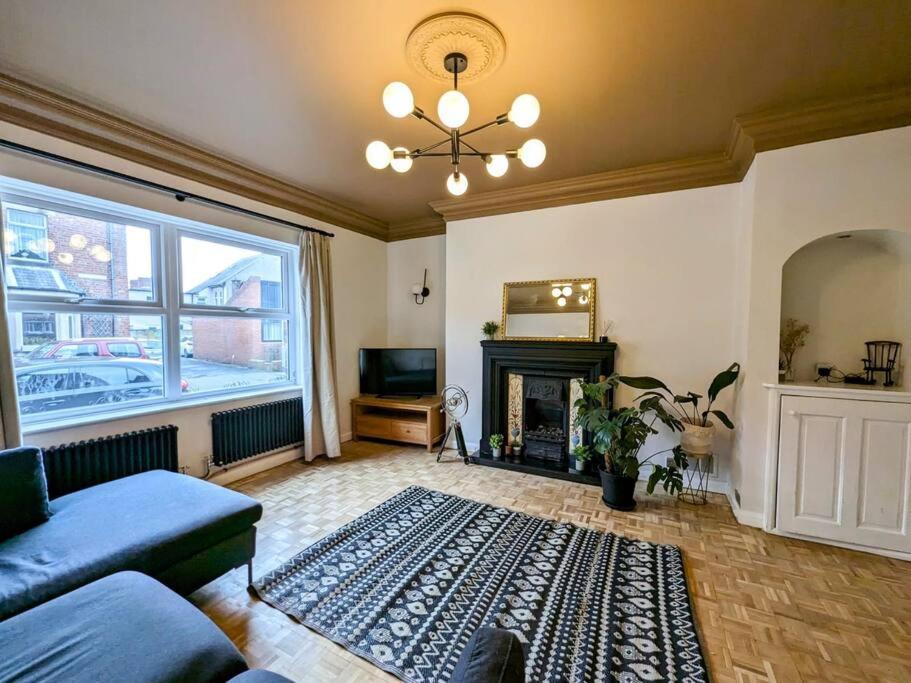 a living room with a couch and a fireplace at Beautiful 2 BR home close to the city in Morpeth
