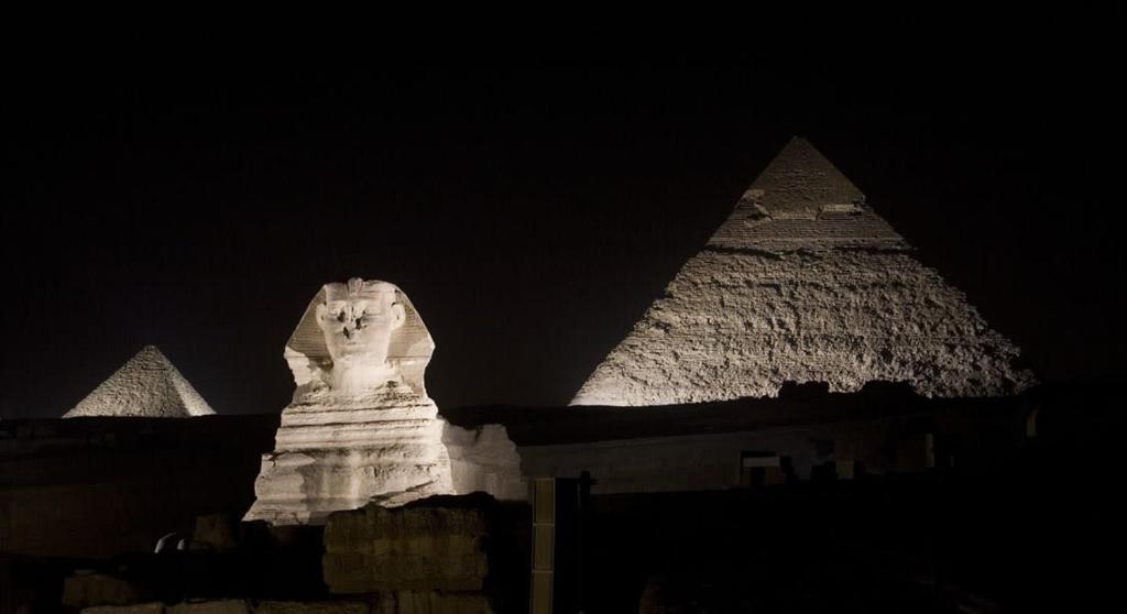 a view of the sphinx and the pyramids at night at Mondy Pyramids Hotel in Cairo