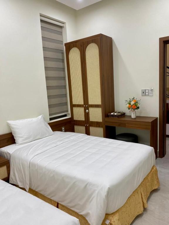 Postel nebo postele na pokoji v ubytování Lena Homestay & Villa