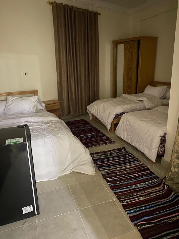 Postel nebo postele na pokoji v ubytování RAAK HOTEL فندق راك
