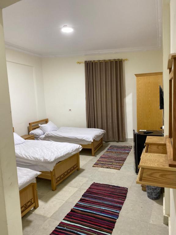 Postel nebo postele na pokoji v ubytování RAAK HOTEL فندق راك