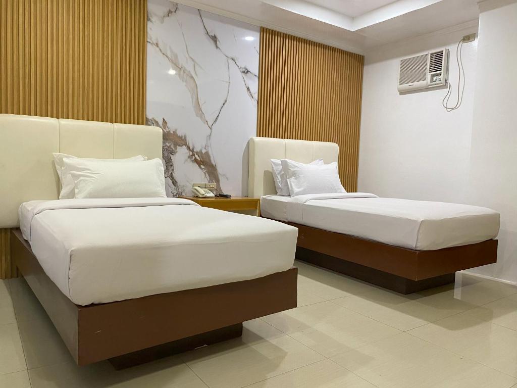 Postel nebo postele na pokoji v ubytování LM METRO HOTEL